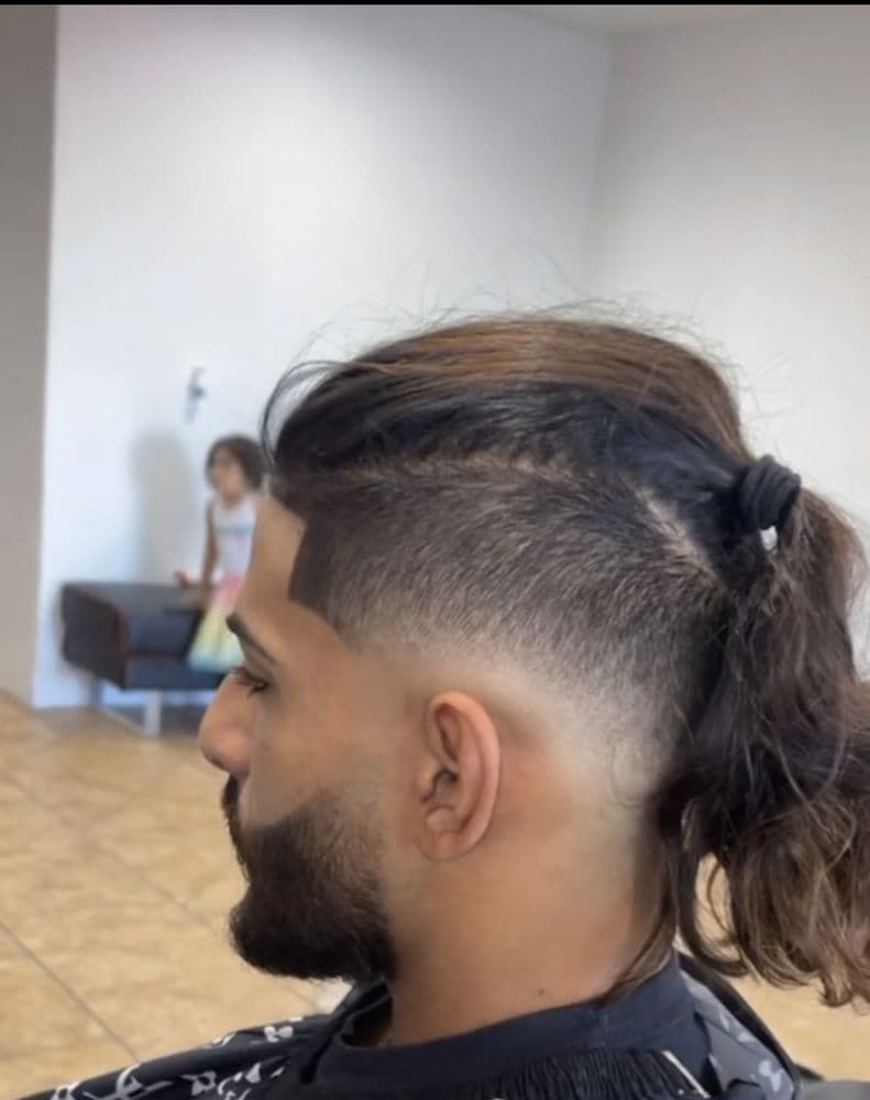 Skin fade with a tied top, photographed in the shop