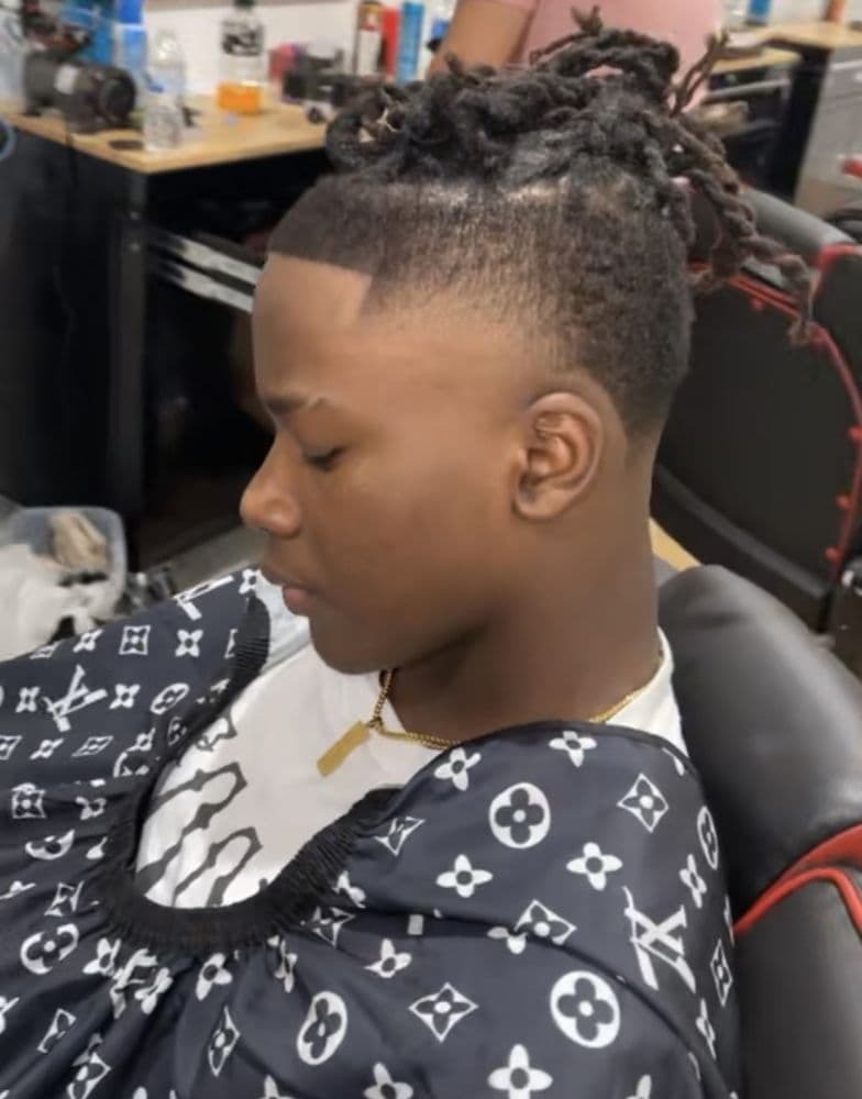 Tapered cut with locs on top, photographed at JayJ's Barber Shop